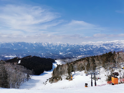 Scenic view of Washigatake Ski Resort in Japan with a ski lift against a picturesque winter backdrop in Chūbu, Gifu, Honshu, emphasizing winter sports ambiance.