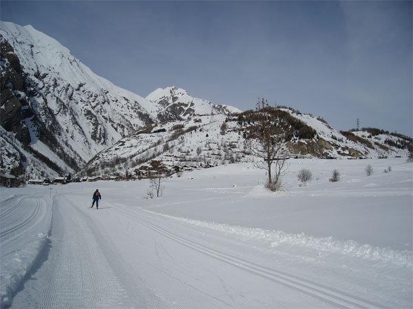 Centro sci di fondo in Italy - a person skiing down a snow covered road.