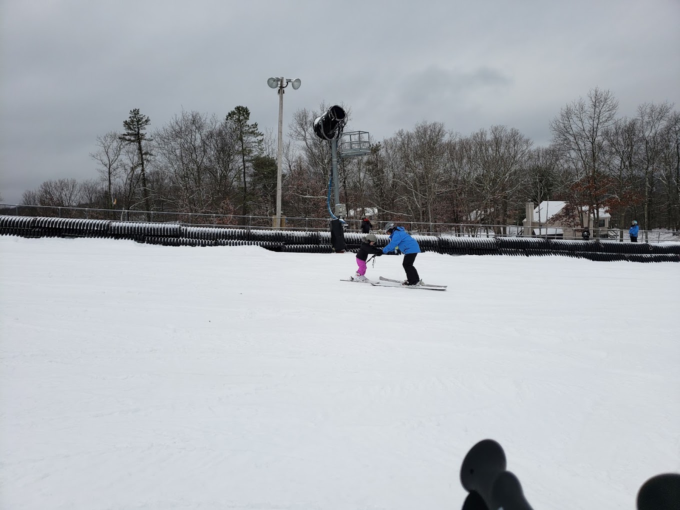 Ski Big Bear at Masthope Mountain in USA - a person riding skis down a snowy slope.