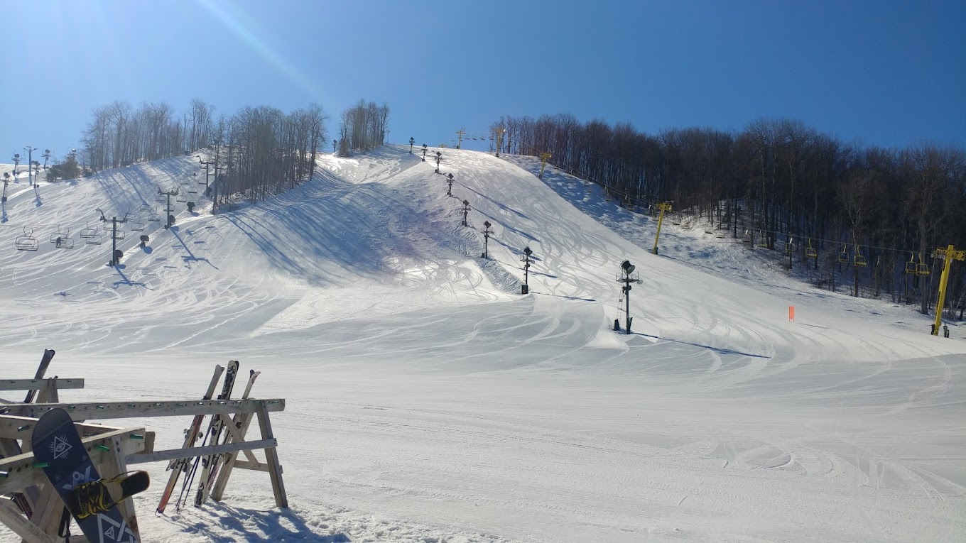Nubs Nob Ski Area in USA - a person sitting on a chair in the snow.