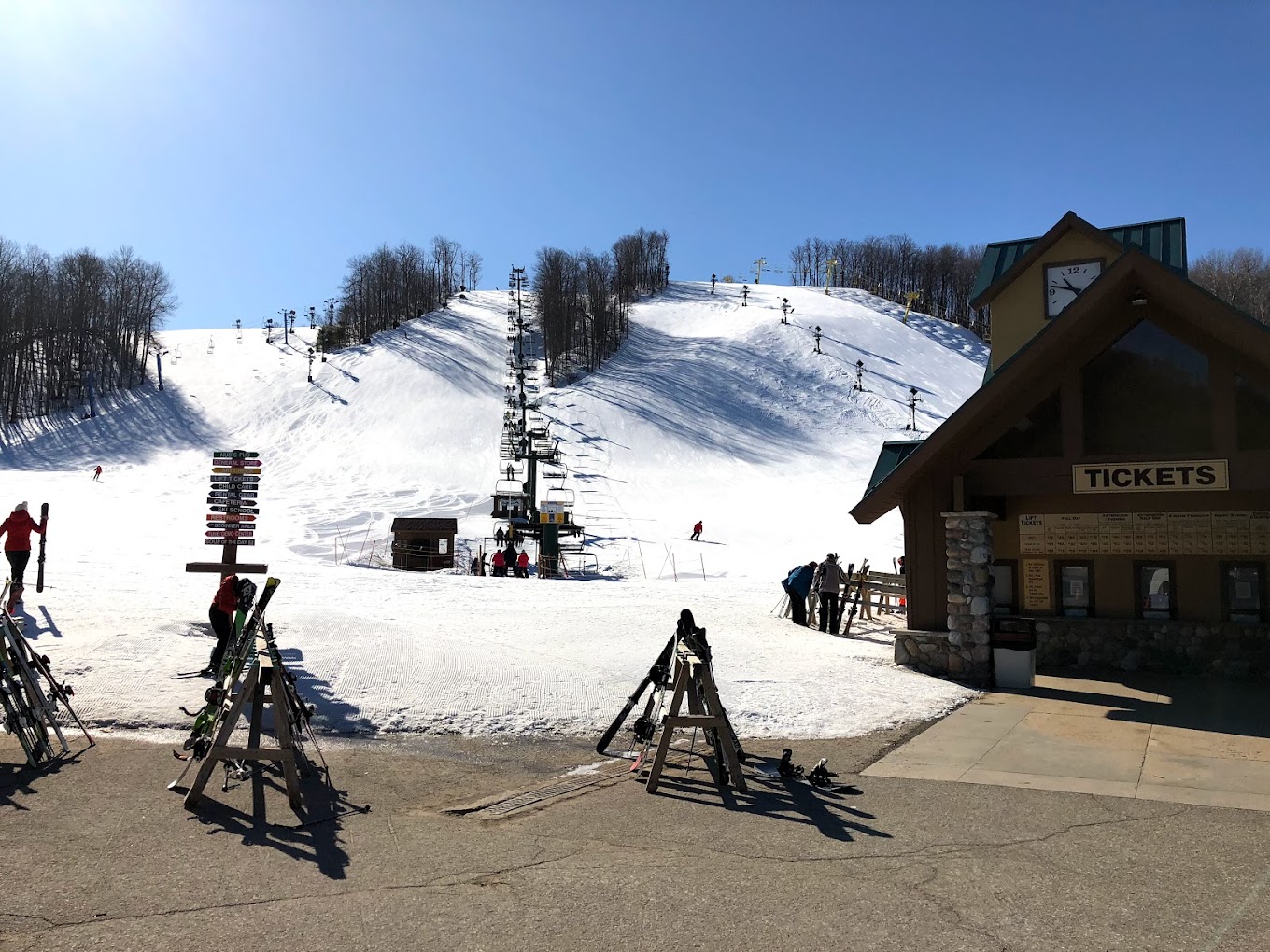 Nubs Nob Ski Area in USA - a group of people standing on top of a snow covered slope.