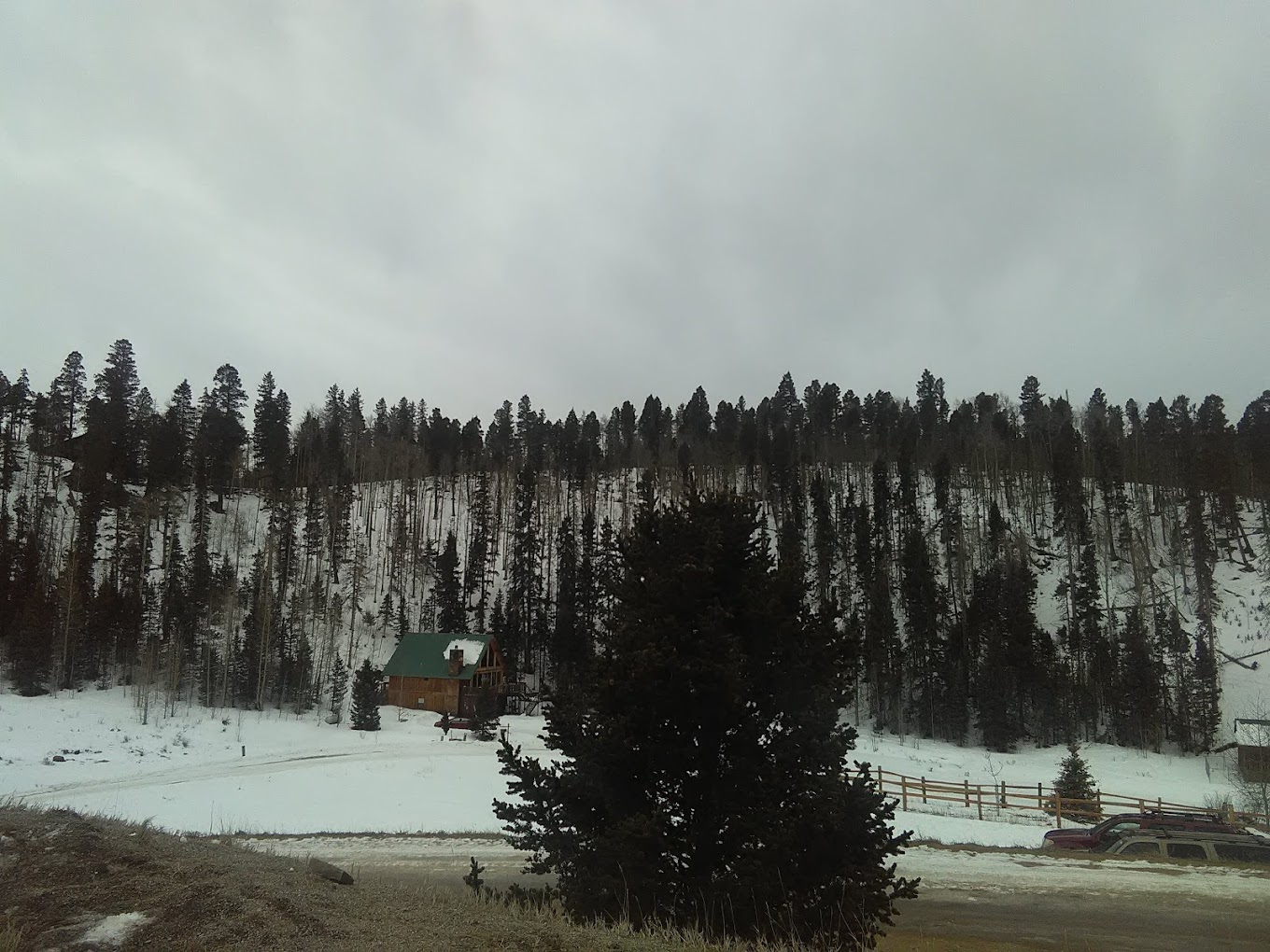 Enchanted Forest Cross Country Ski Area in USA - a snow covered mountain with a small cabin in the distance.