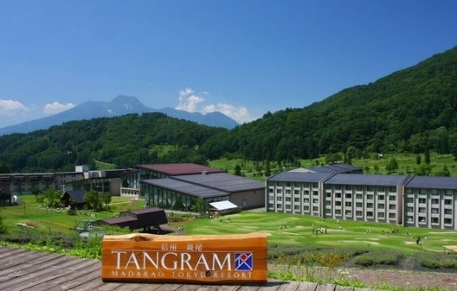 Madarao Tangram in Japan - a view of a golf course with mountains in the background.