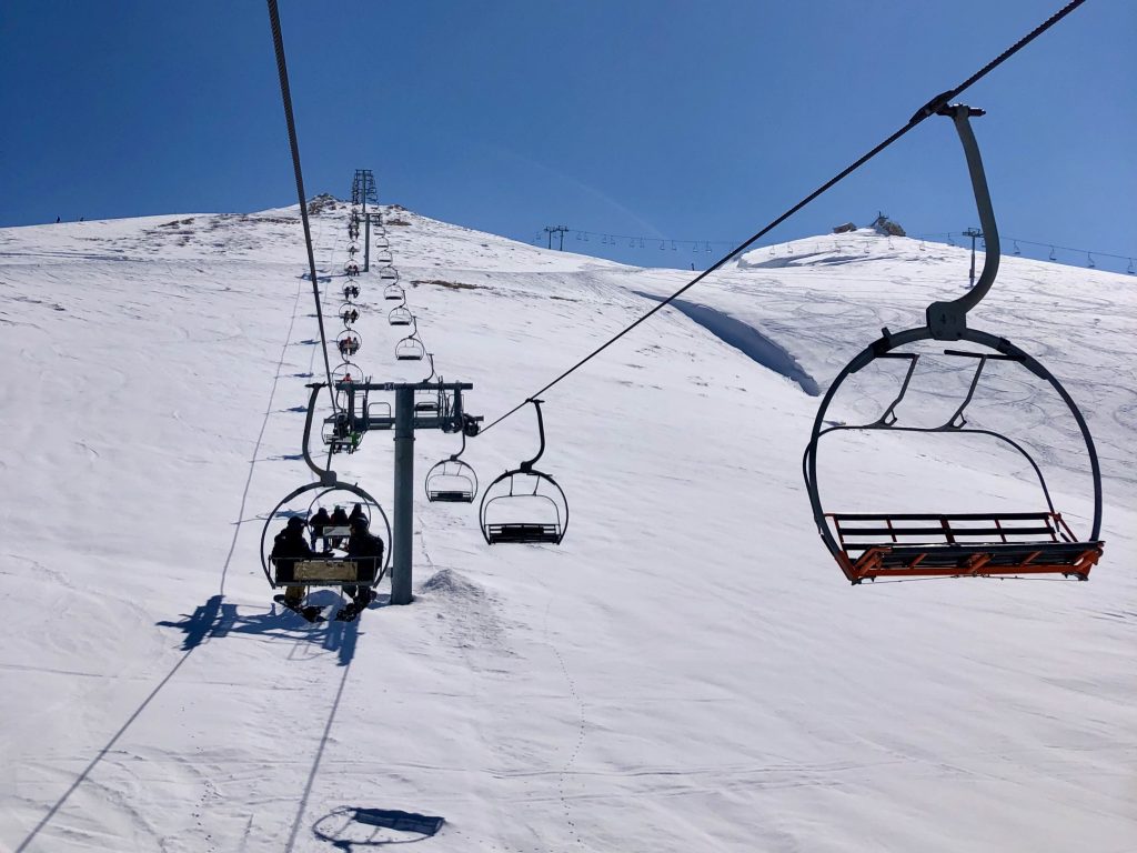 Mzaar Kfardebian in Lebanon - a ski lift going up a snowy mountain.