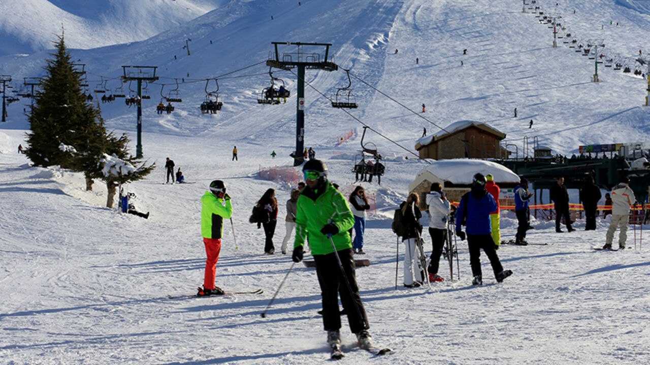 Mzaar Kfardebian in Lebanon - a group of people skiing down a snowy hill.