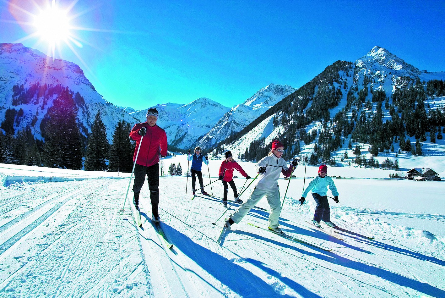 Neunerköpfle – Tannheim in Austria - a group of people skiing down a snowy slope.
