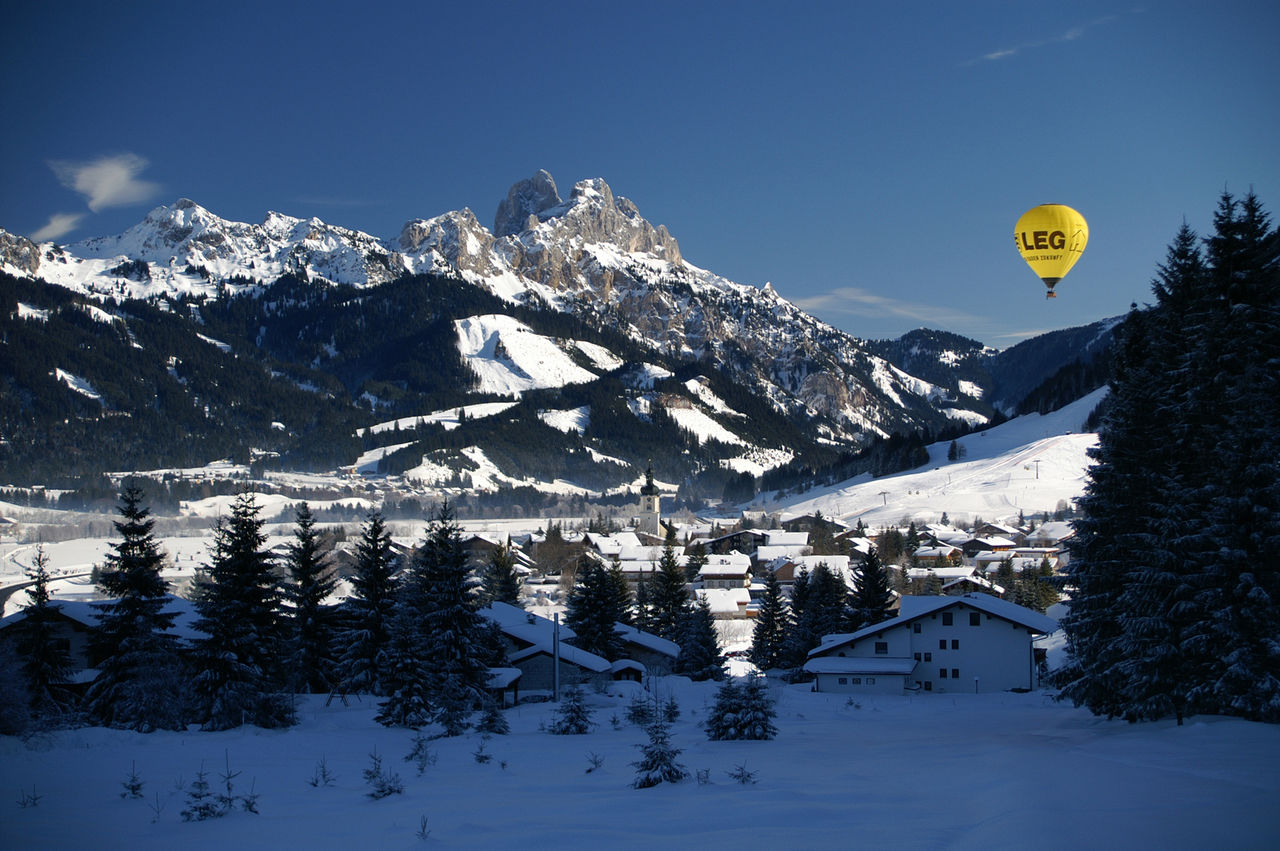 Füssener Jöchle – Grän in Austria - a hot air balloon flying over a snowy landscape.