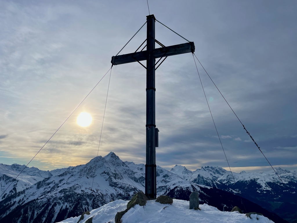Kristberg – Silbertal in Austria - a cross on top of a snowy mountain.