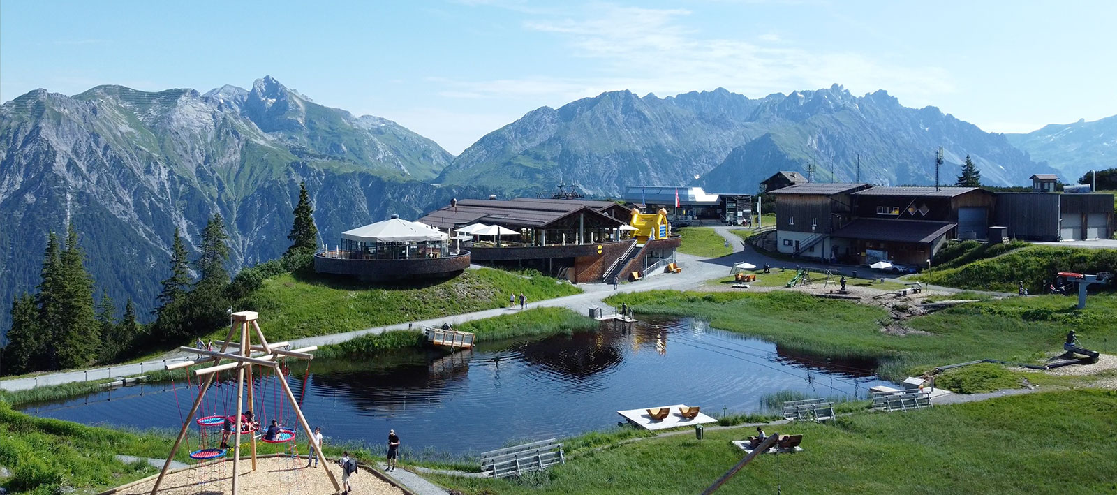 Sonnenkopf – Klösterle in Austria - a small pond in the middle of a grassy area.