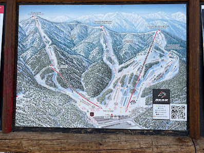 A lively ski resort at Bear Mountain Big Bear Lake California showcasing a ski lift carrying skiers up the snow-covered slopes. Winter sports enthusiasts can be seen enjoying the pristine setting.