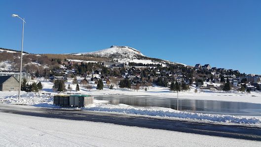 Winter sports scene at Super-Besse in France, featuring a cozy challet, bustling ski resort, and majestic mountain setting.