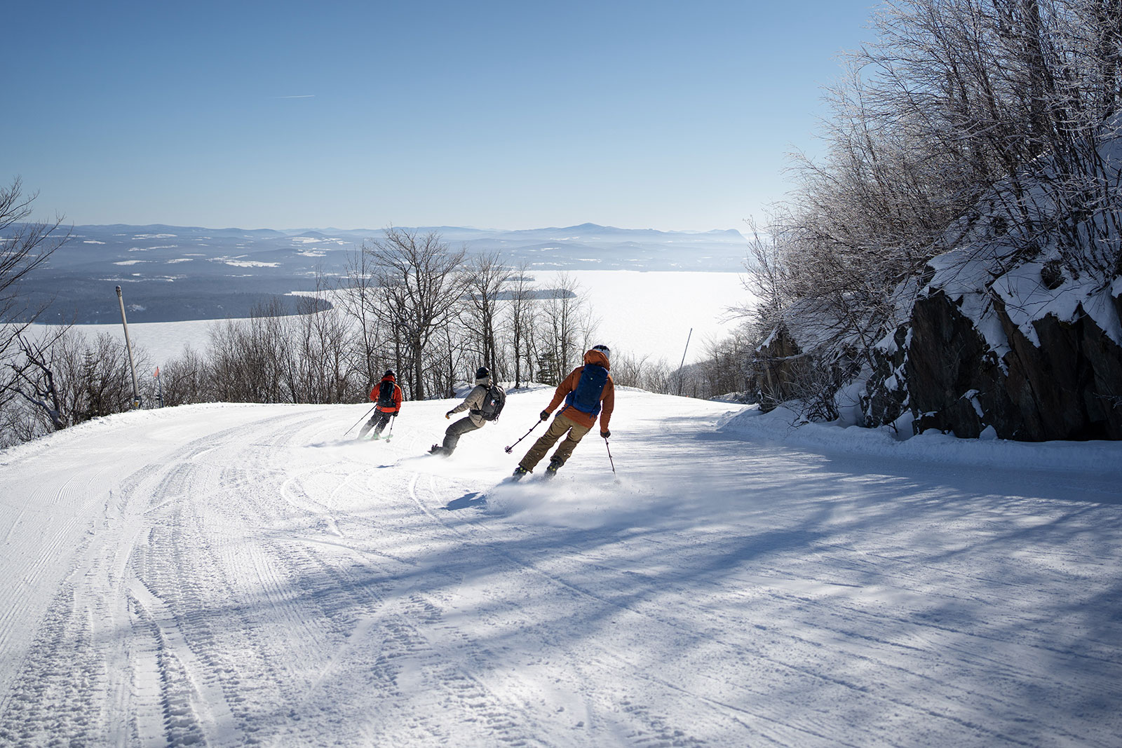 Owl's Head in Canada - a couple of people skiing down a snowy slope.
