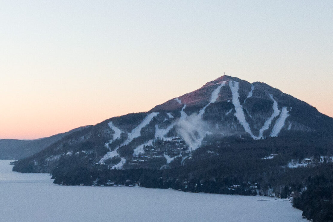 Owl's Head in Canada - the sun is setting on a snowy mountain.