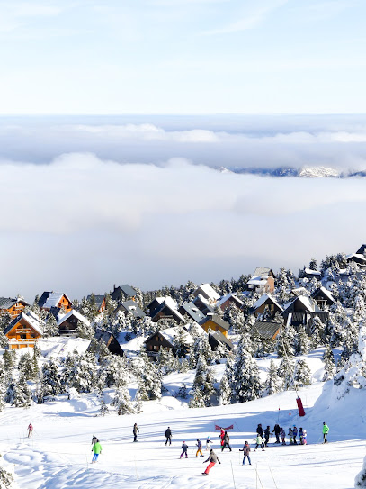 A picturesque view of La Pierre Saint Martin ski resort in France brimming with a beautiful winter scenery. The scene depicts winter sports in a breathtaking winter landscape and a cozy chalet nestled in the snow.