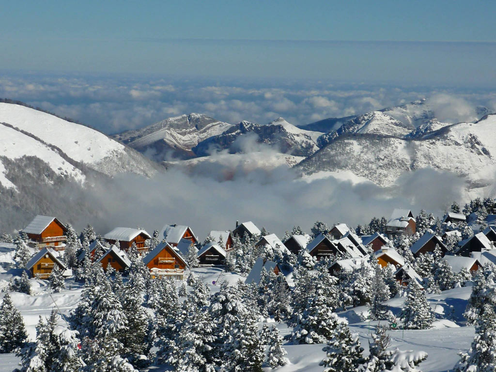 La Pierre Saint Martin in France - a view of snow covered mountains and trees.