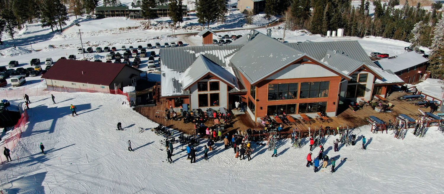 Terry Peak in USA - a group of people standing on top of a snow covered hill.