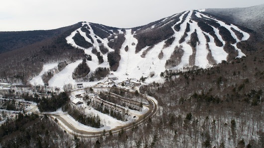 View of Antagnod Pian Pera ski resort in Italy's Monte Rosa region, depicting a lively winter sports scene set against snow-covered slopes and a majestic mountain backdrop.