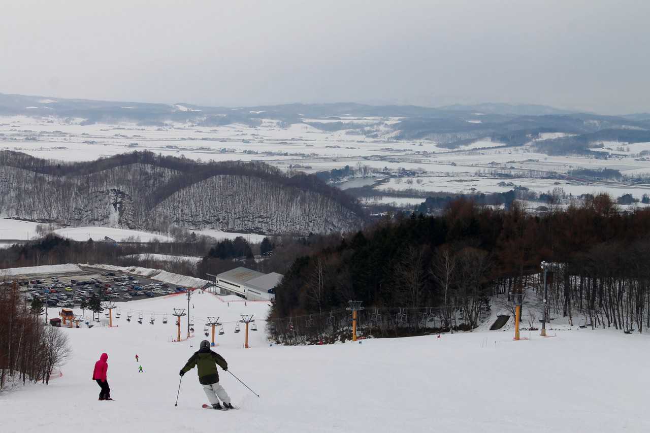 Kamui Ski Links in Japan - a group of people skiing down a hill.