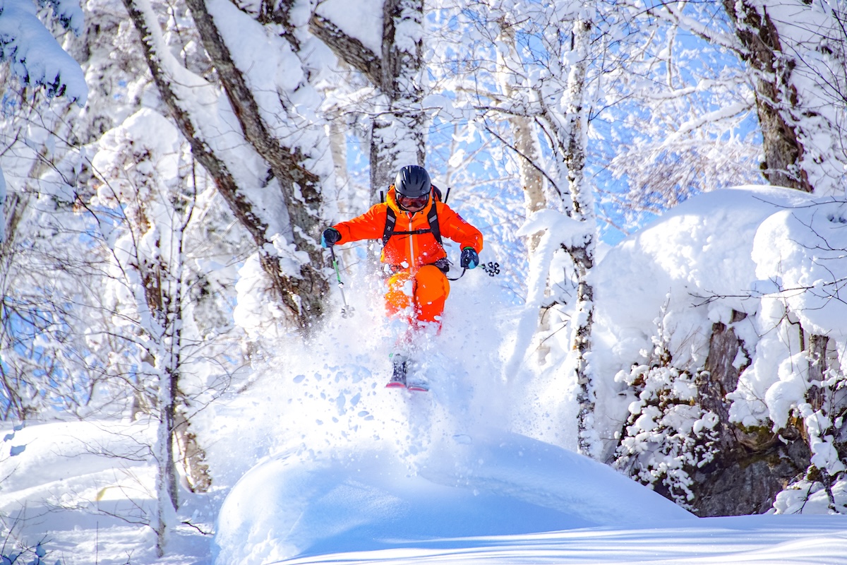 Kamui Ski Links in Japan - a person on a snowboard in the snow.