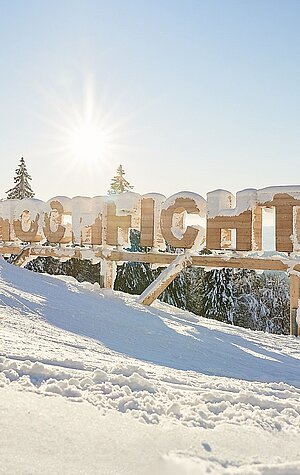 Winter sports scene at Hochficht in Mühlviertel, Upper Austria with a challet nearby. It's a sunny day making the stunning winter scenery even more beautiful.