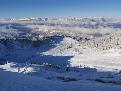 View of Ragged Mountain ski resort in New Hampshire, featuring snow-covered slopes and a challet. The scene exudes a stunning winter ambiance perfect for winter sports.