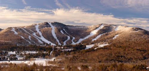 A vibrant winter scene captured at Myoko Akakura Kanko ski resort in Myoko, Japan. The image showcases snow-covered slopes dotted with skiers, a ski lift ascending the mountain, painting a perfect picture for winter sports enthusiasts.