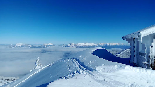 Skier at the Collet ski resort in Allevard, France. The scene perfectly captures a gorgeous snowy mountain in the backdrop and a vibrant winter sports scene.