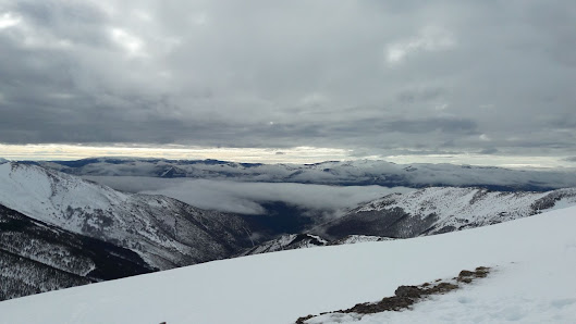 View of a charming chalet nestled in Snowshoe Mountain, West Virginia. The picturesque winter landscape showcases a vibrant ski resort amidst snowy mountains, capturing the essence of winter sports excitement.