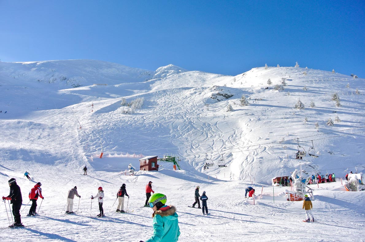 Valdezcaray in Spain - a group of people skiing down a snowy mountain.