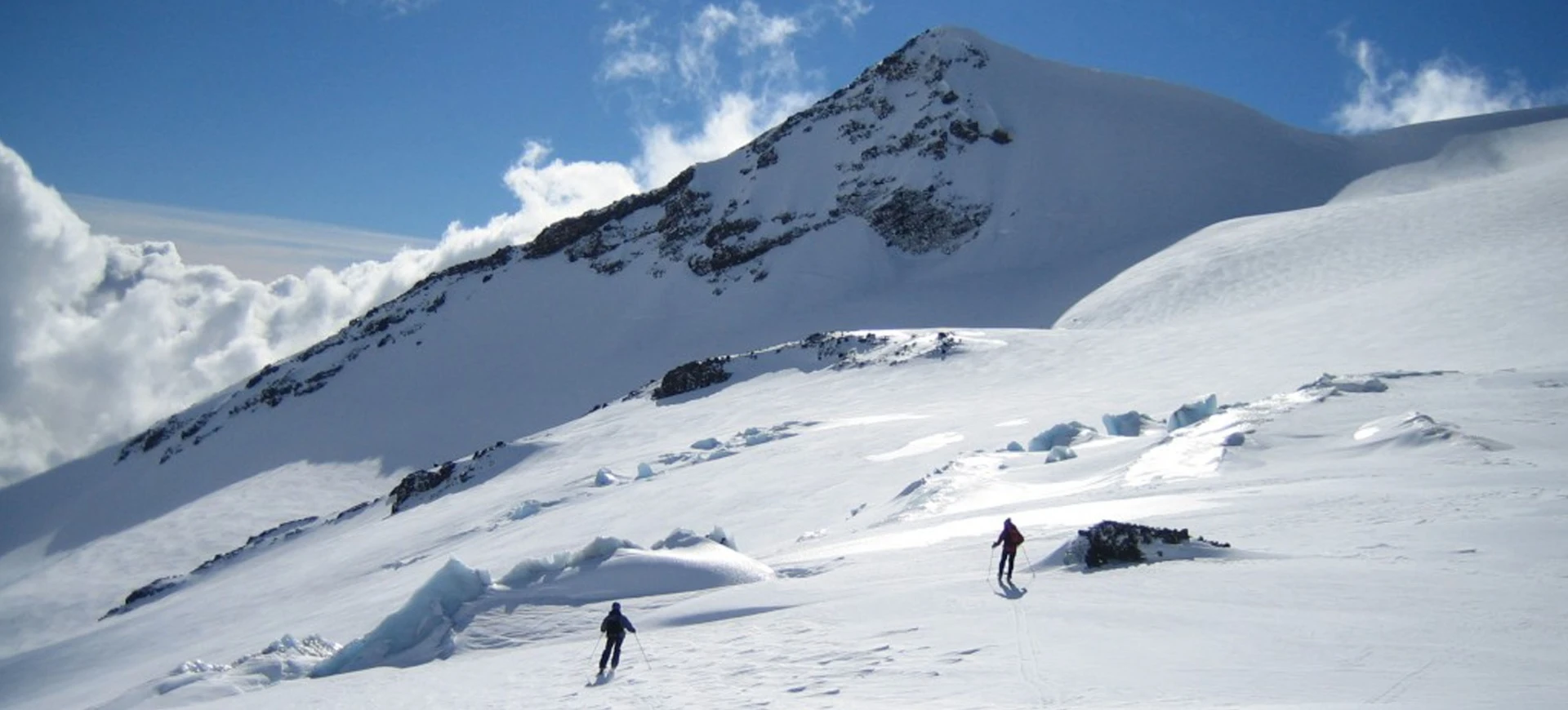 Nevados de Chillan in Chile - a group of people walking up a snow covered mountain.