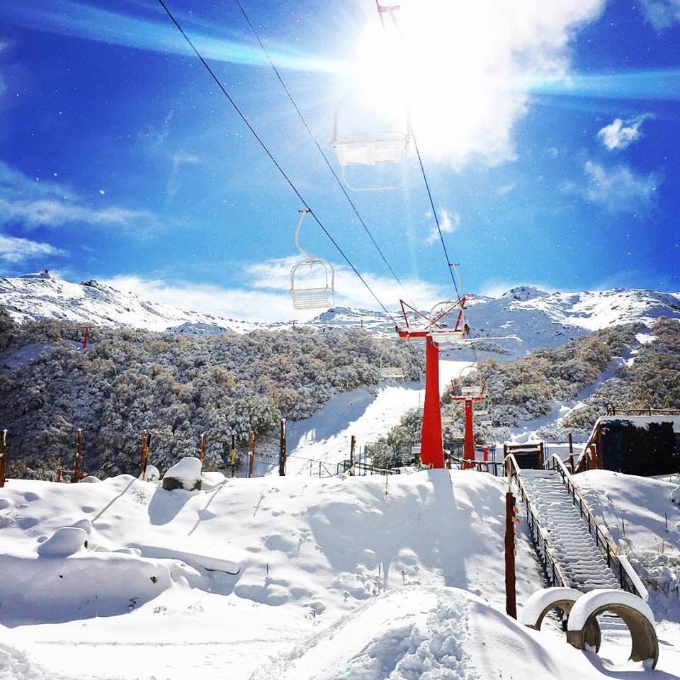Nevados de Chillan in Chile - a ski lift going up a snowy mountain.