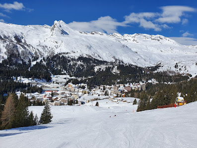 A scenic view of Nevados de Chillan ski resort in Chile featuring a challet winter sports enthusiasts on snow-covered slopes nestled in a vibrant winter landscape.