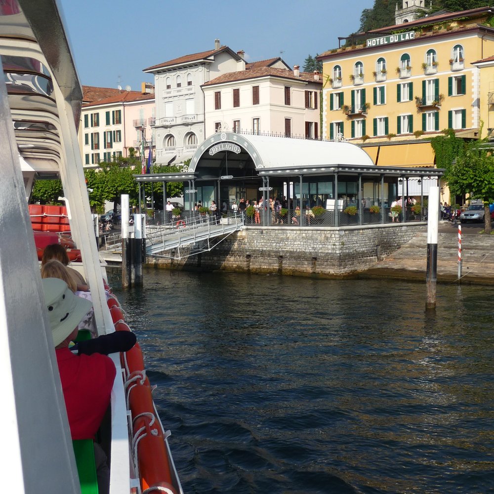 Sant Bernardino Pian Cales in Switzerland: a boat traveling down a river with buildings in the background.