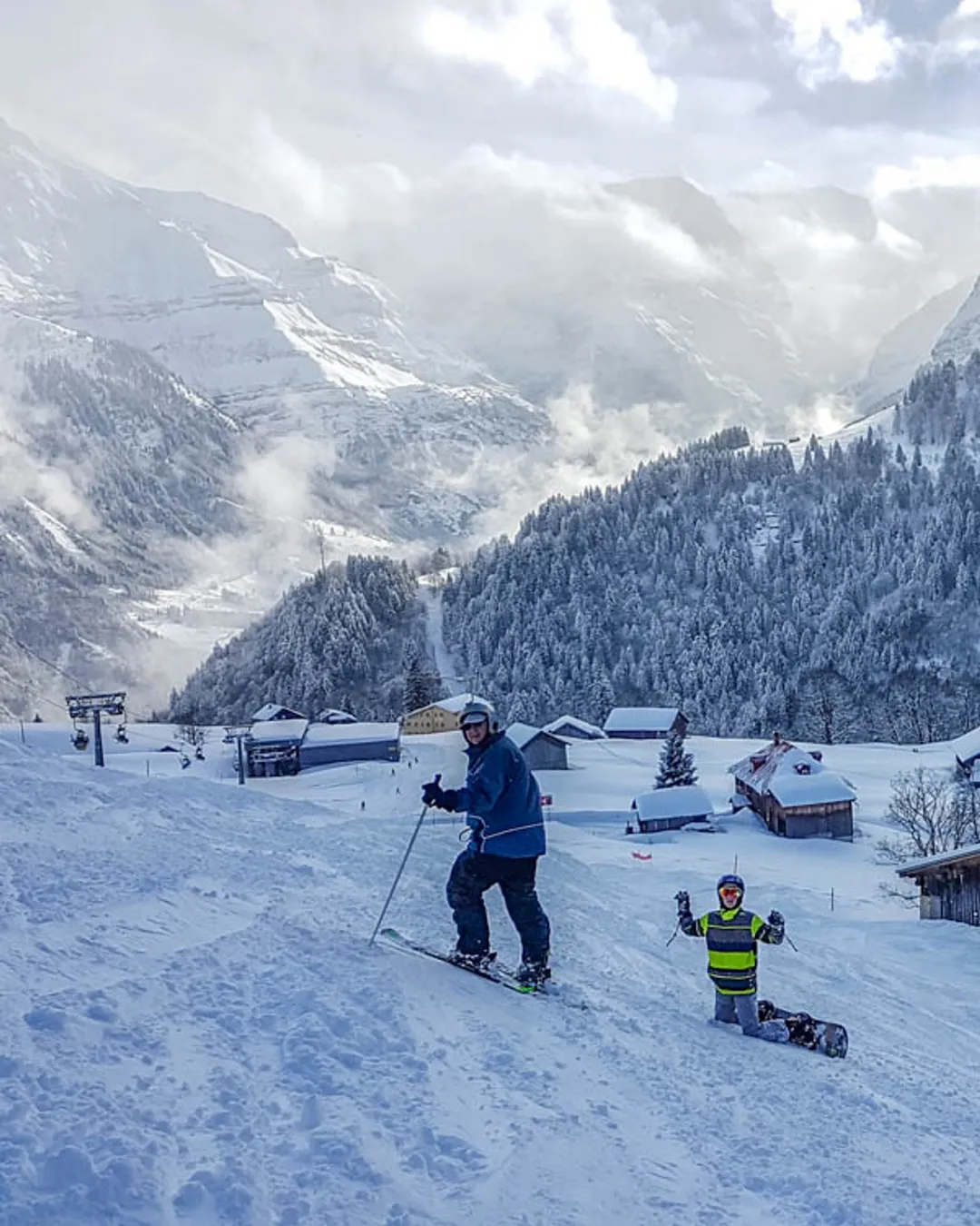 Braunwald in Switzerland - a group of people skiing down a snow covered mountain.