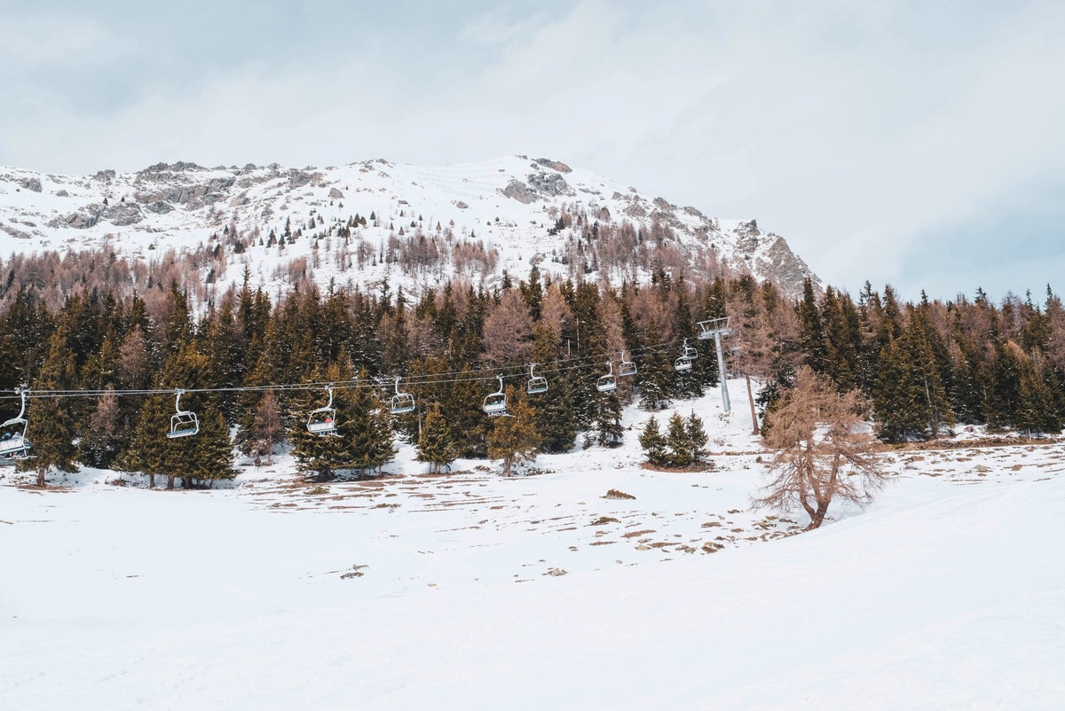 Impianti Risalita Torgnon Cervino in Italy - a snow covered mountain with a ski lift in the background.