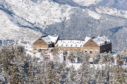 Ski resort at Schwarzsee in Fribourg, Switzerland featuring a chalet amidst a stunning winter landscape. Scene captures active winter sports in progress.