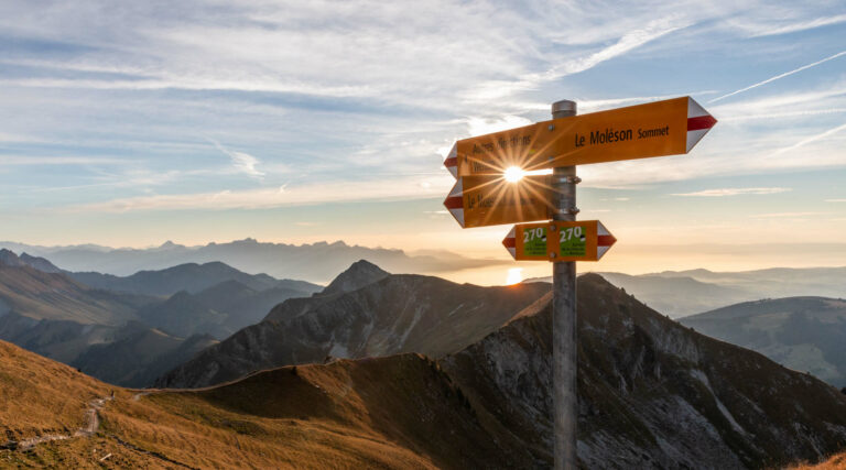 A charming chalet nestled amid the stunning winter scenery in Schwarzsee, Fribourg, Switzerland. The sunny day highlights the serene beauty of the mountains, encouraging winter sports activities.