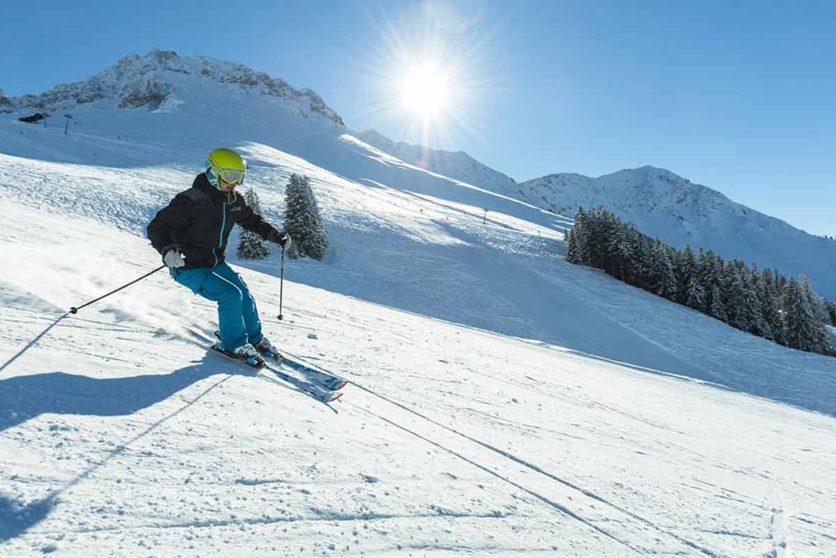 Schwarzsee in Switzerland - a person skiing down a snow covered mountain.
