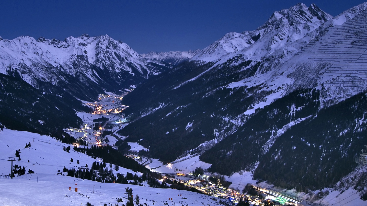 Ski Arlberg, St Anton in Austria: a view of a ski resort at night.