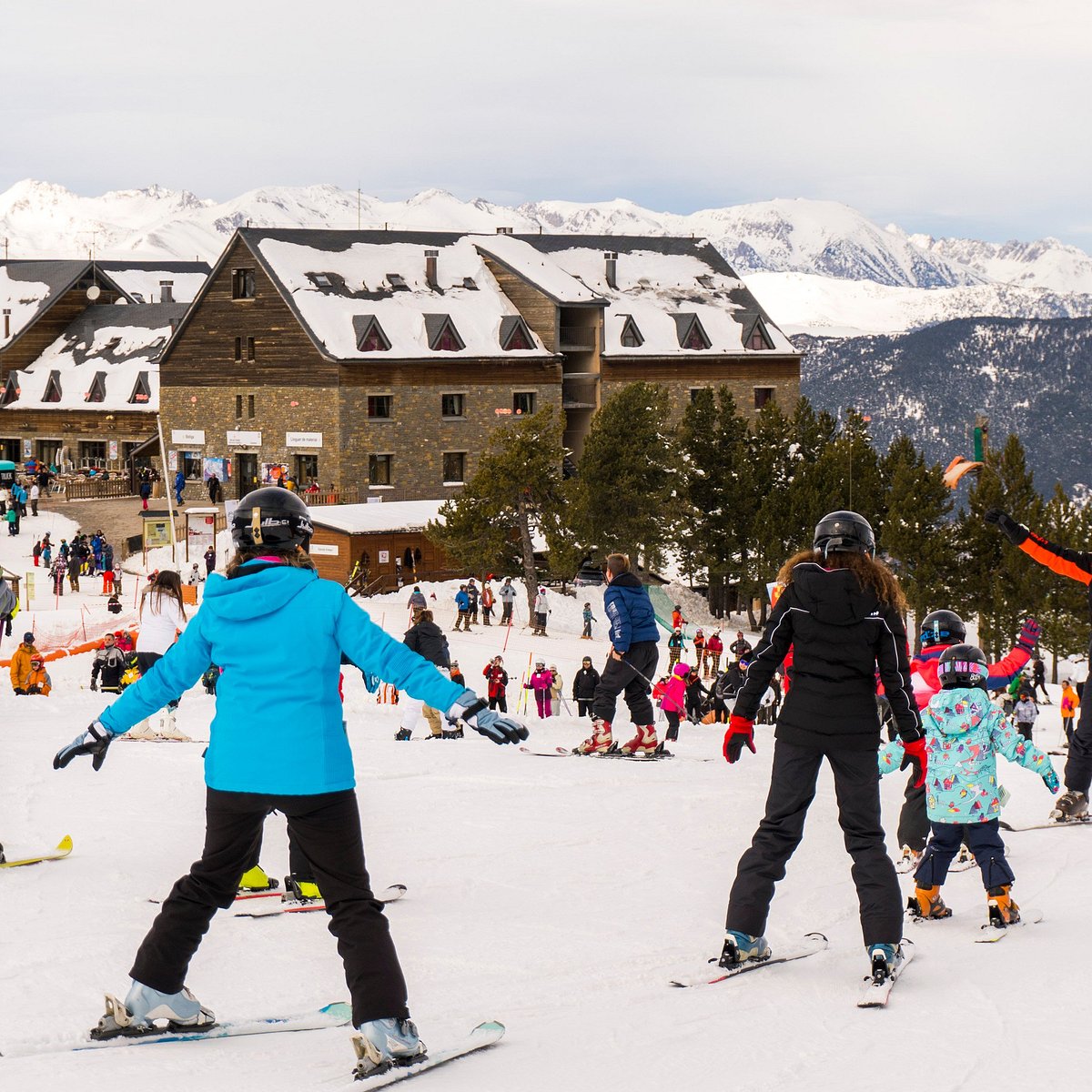 Port Ainé in Spain - a group of people riding ski boards down a slope.