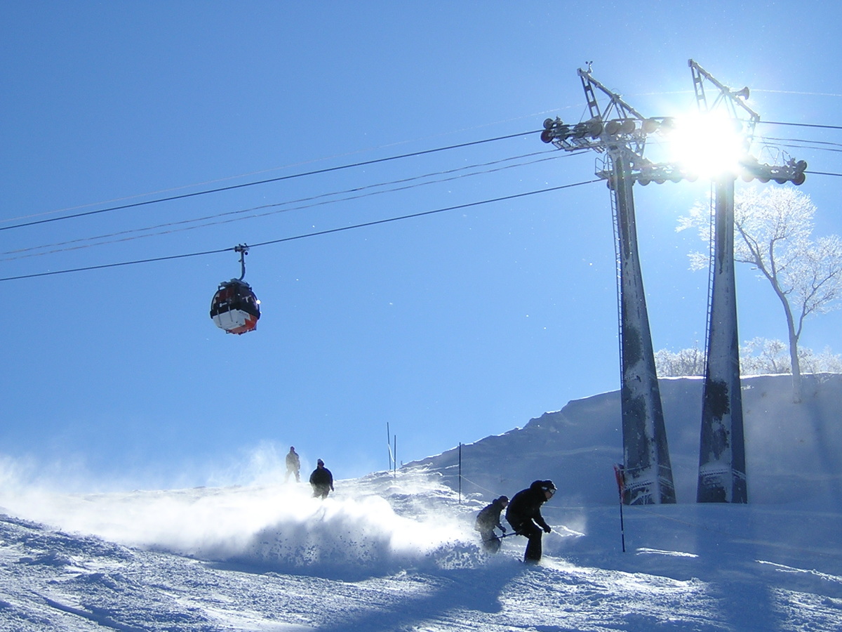 Mizuho Highland in Japan - a person on a snowboard going down a hill.