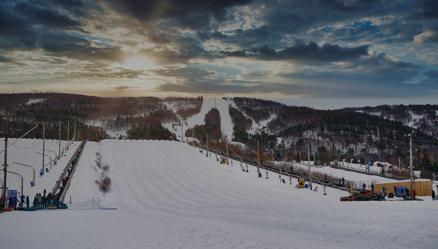 Blue Mountain in USA - a snow covered ski slope with people on it.