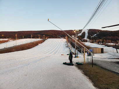 Ski resort at Blue Mountain, Pennsylvania featuring winter sports scene with a ski lift and a skier in action.
