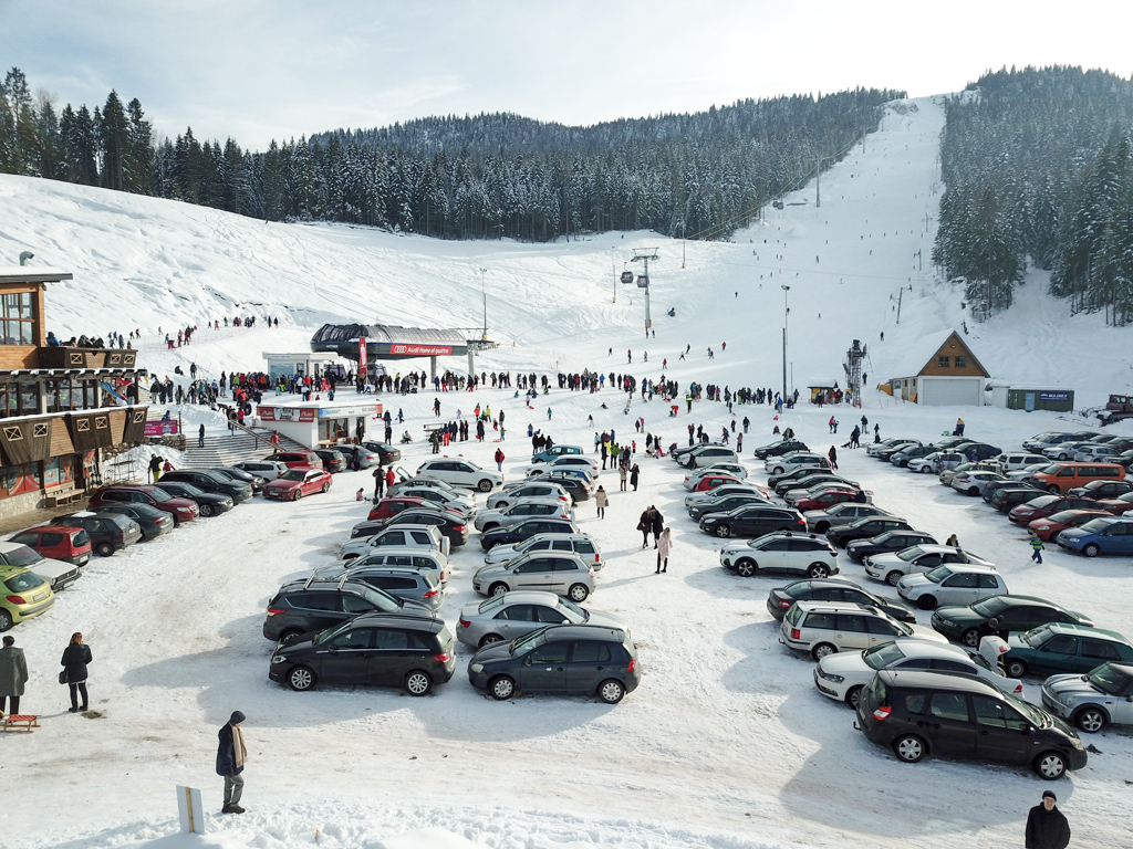 Ravna Planina in Bosnia and Herzegovina - a parking lot filled with cars in the snow.