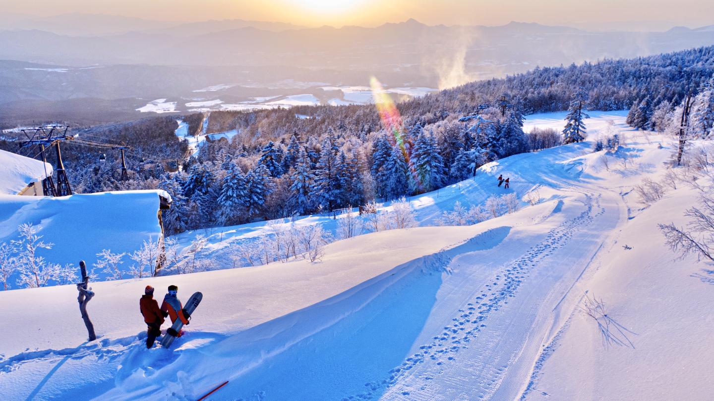 Palcall Tsumagoi in Japan - a group of people skiing down a snowy mountain.