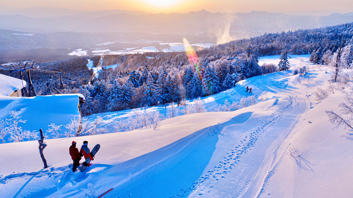 Palcall Tsumagoi in Japan - a group of people skiing down a snow covered mountain.