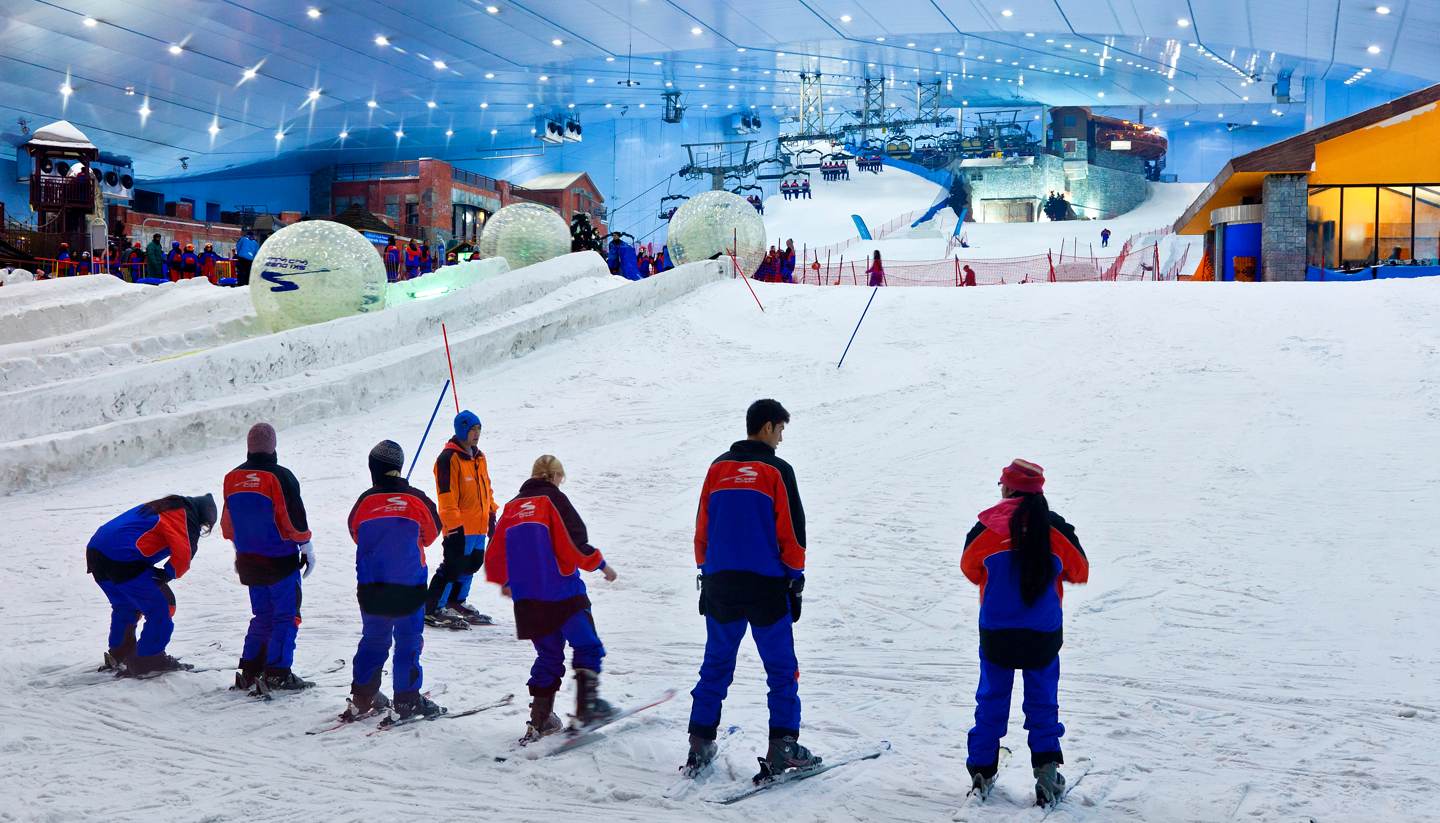 Ski Dubai – Mall of the Emirates in United Arab Emirates - a group of people skiing down a snowy slope.
