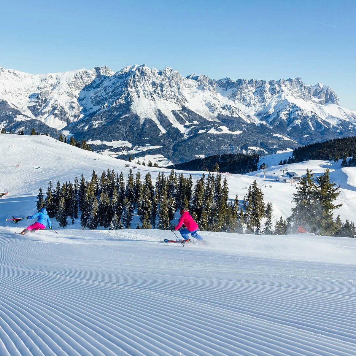 SkiWelt -Brixental in Austria - a group of people skiing down a snow covered slope.