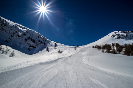 Winter scene at Valgrande-Pajares ski resort in Spain highlighting a ski chalet amidst a snow-filled landscape, buzzing with winter sports activities.
