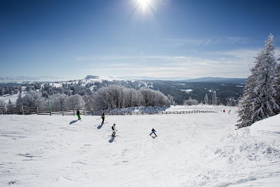 A vibrant winter sports scene at the ski resort in Abriès Hautes-Alpes France with surrounding winter scenery and chalet tucked amidst snow-capped mountains.